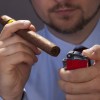 Man holding cigar and lighter